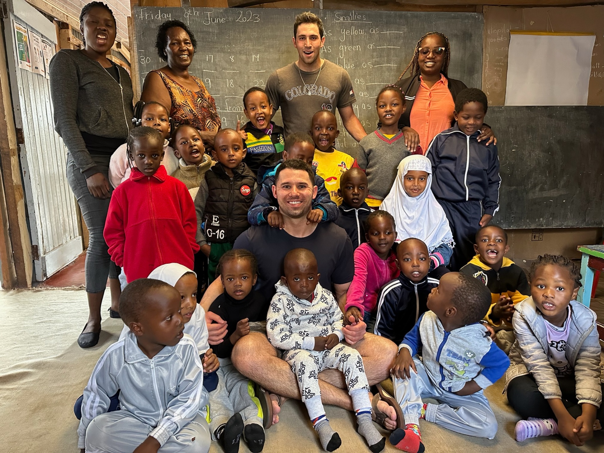 Mama Joy with the children and teachers of the school she hosts in her own backyard in Nairobi